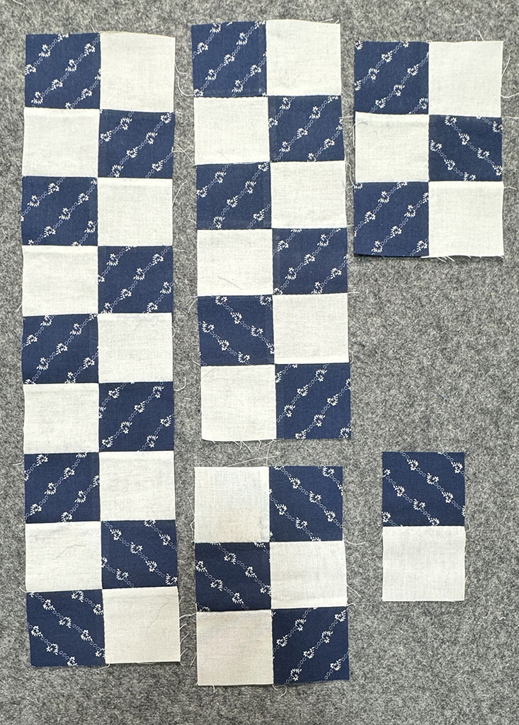 Several strips of alternating blue and white squares, forming patches.