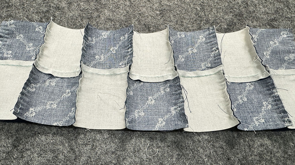 Nine 2-patch pieced together, view from the back. The horizontal seams were pressed but the vertical seams haven't yet been pressed.