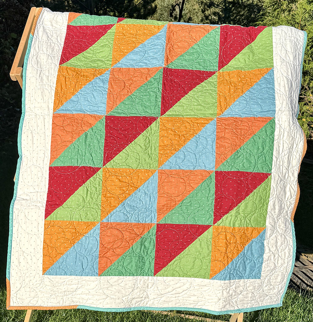 series of colorful large half square triangles in orange, blue, yellow, green, and red.