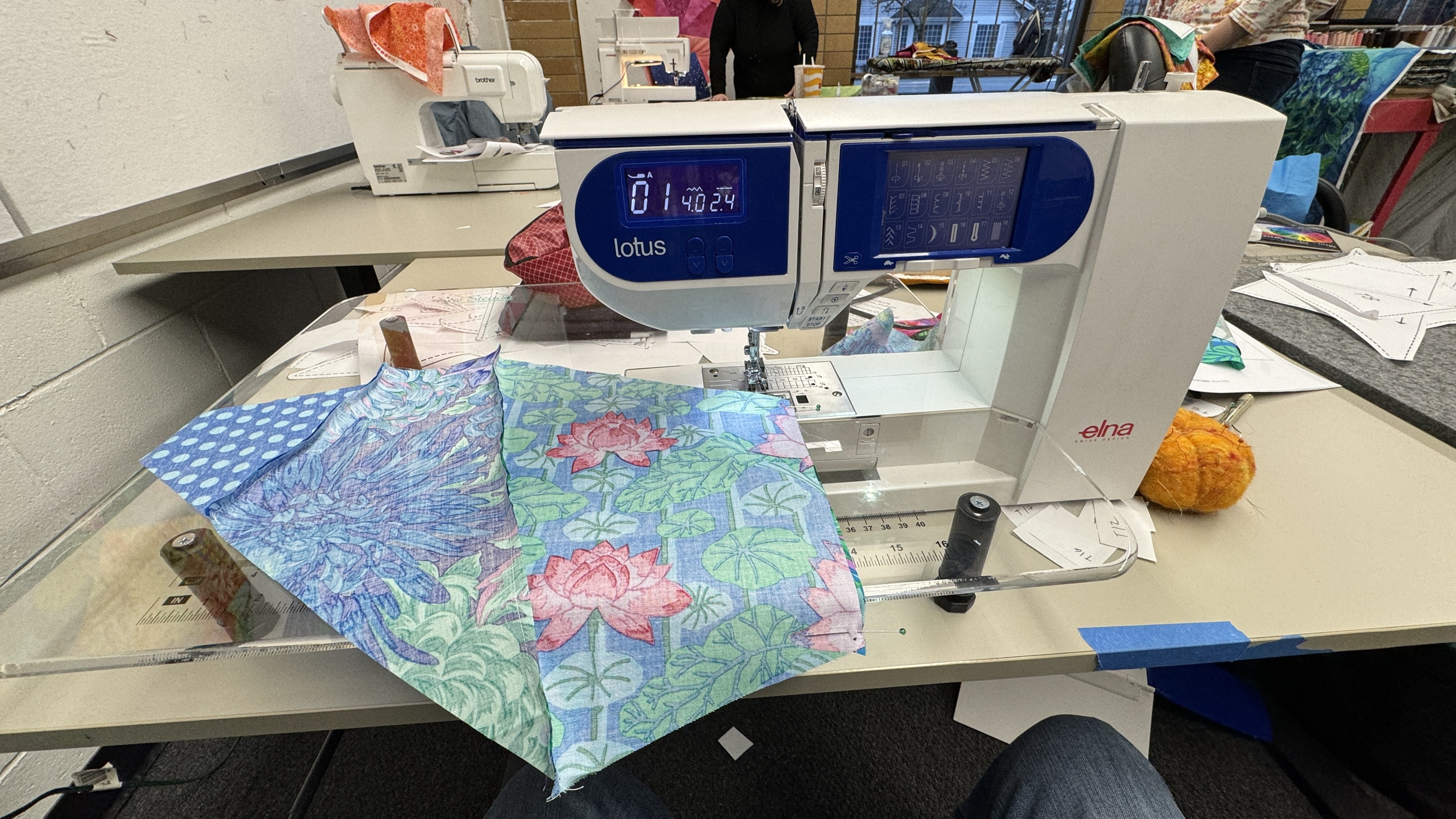 Blocks of fabrics on a small Elna Lotus sewing machine