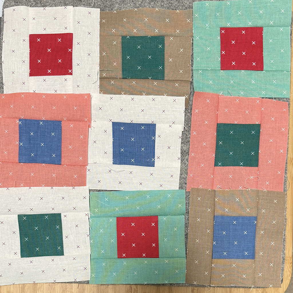9 smaller squares in 3 rows of 3 columns. Each square has a different color center square