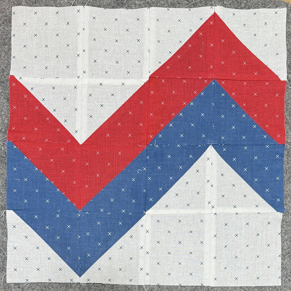 Colored strips forming a large zigzag pattern on the block