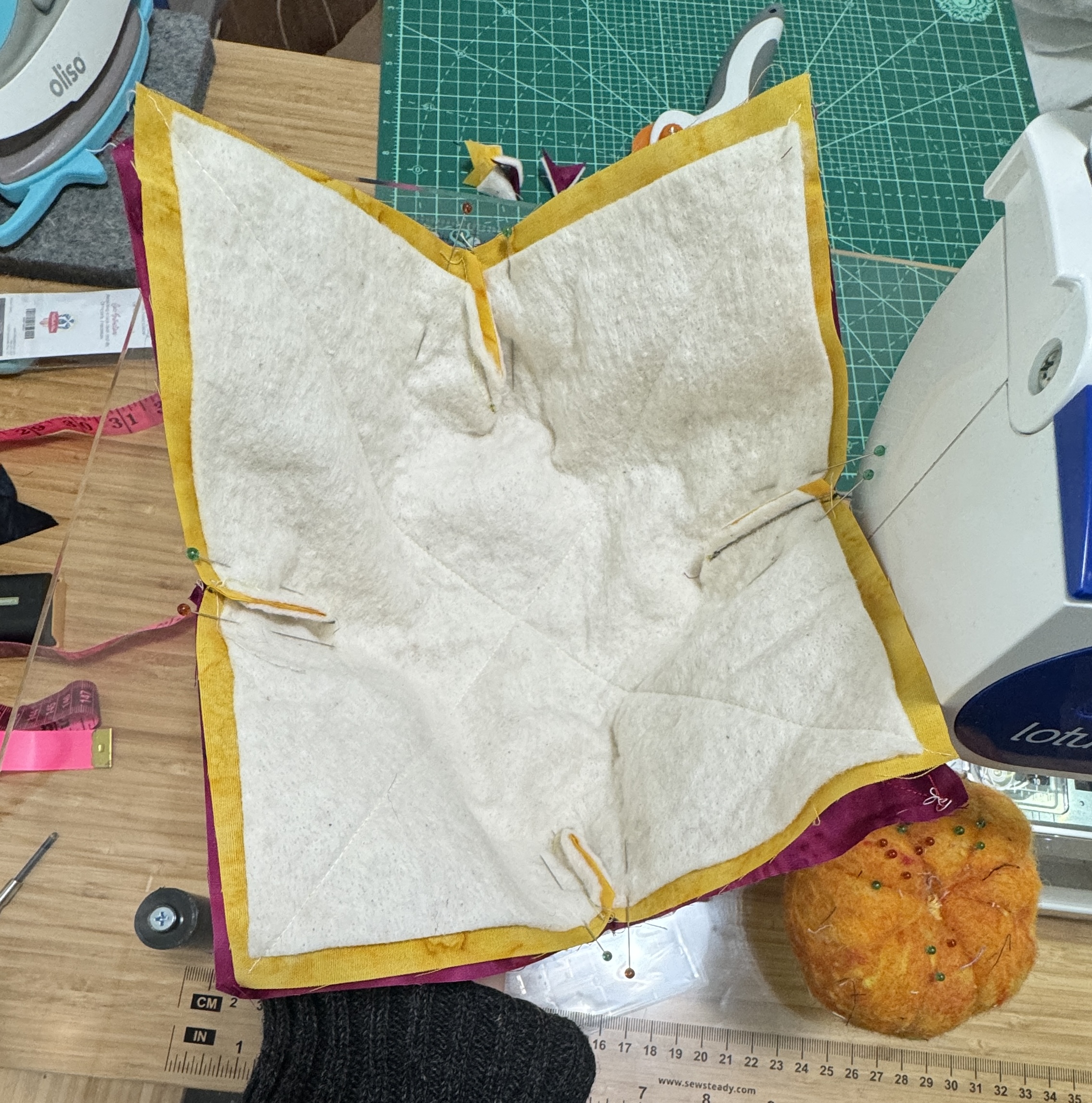 Fabric units, cut and pinned together, starting to form a bowl.