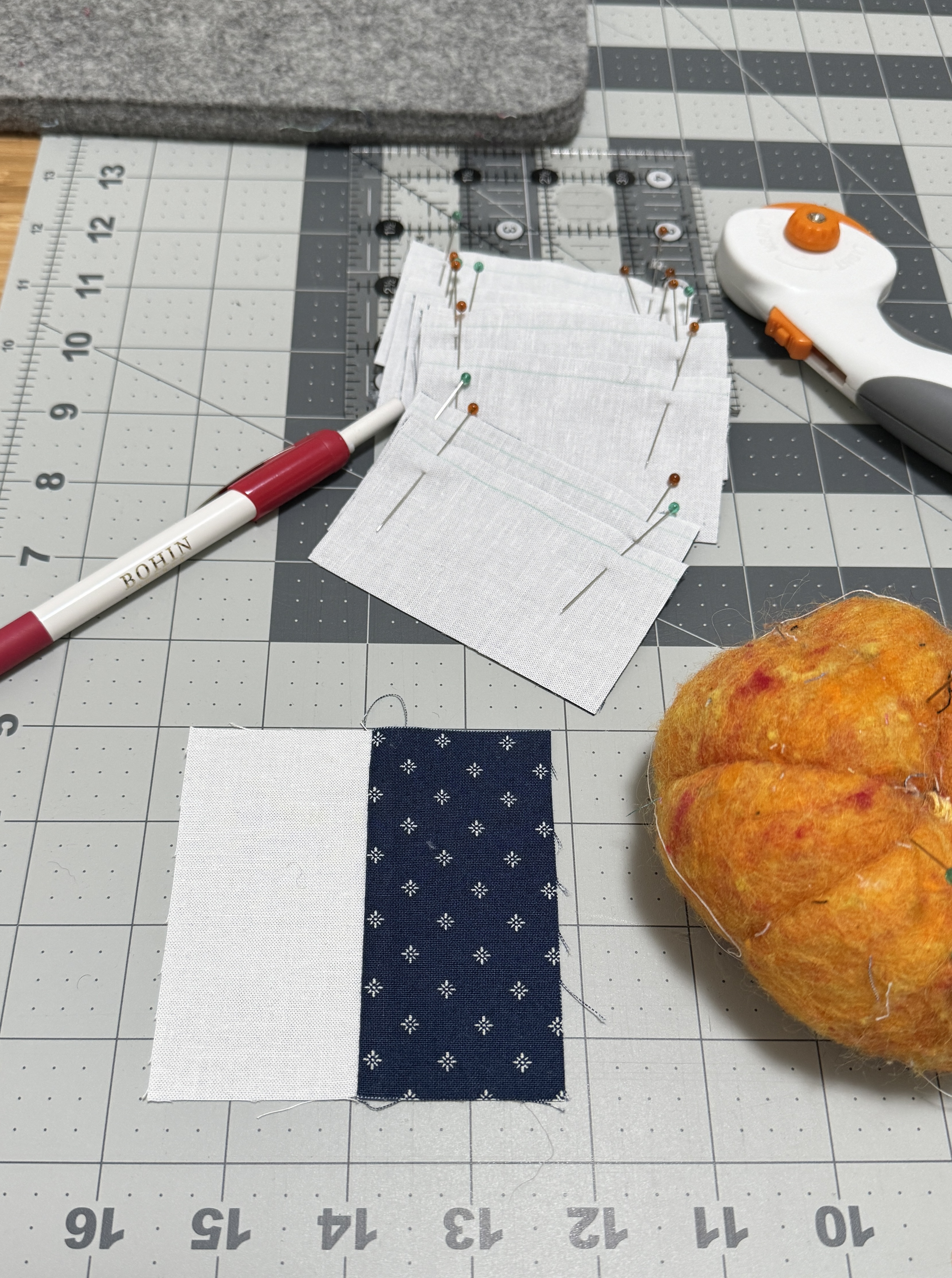 Stack of 8 pinned fabric pairs, and one completed chinese coin