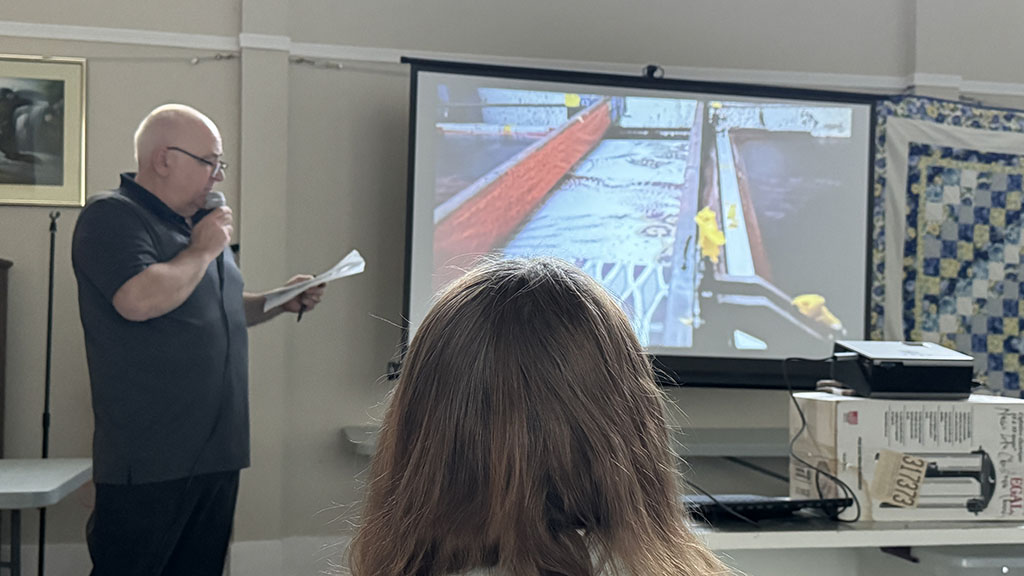 Laurie, talking about the different types of fabric printing, with a slide showing a flatbed screen printing machine