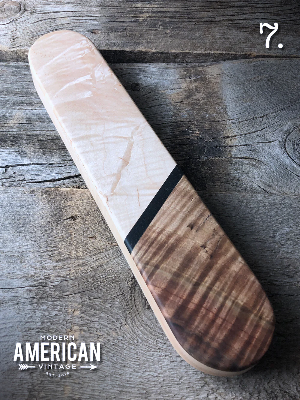 Tailors clapper, a 2.5 inches by 12 inches by 1 inch block of hardwood with fancy wood veneer decoration on top.